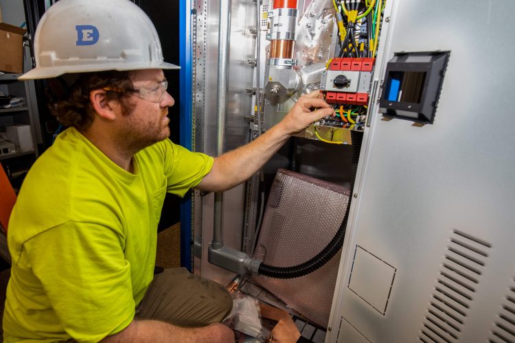 Electrician inspecting wiring